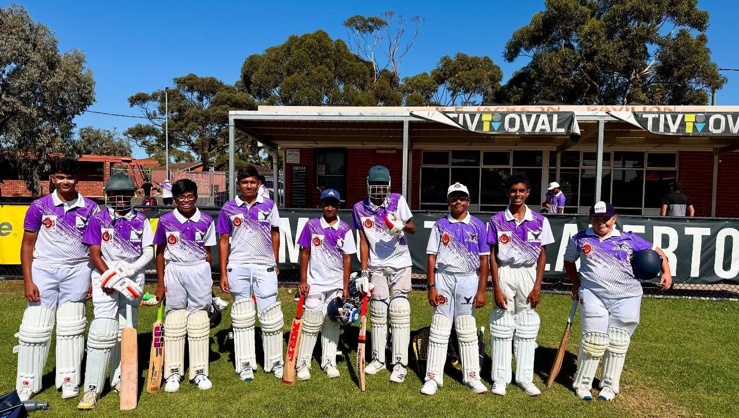 Western Falcons players lined up in front of the pavilion at Laverton, pads on and bats in hand.